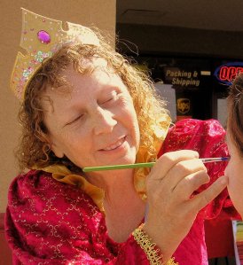 Maggie making magic with face paint